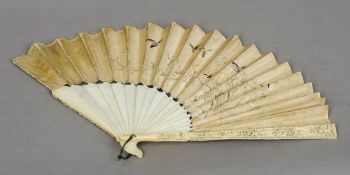 A 19th century Canton carved ivory and silk work fan
The silk panel embroidered with birds and