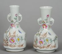 A pair of Chinese porcelain twin handled vases
Decorated with insects and floral sprays, the