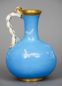 A Mintons pate-sur-pate ewer
Decorated with a bird and butterfly amongst floral sprays, on a