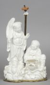 A 19th century Chinese blanc de chine figural group
Formed as two figures, one holding a bat and a