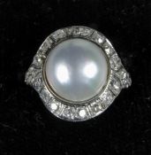 An Art Deco pearl and diamond set platinum target ring
In fitted case. CONDITION REPORTS: