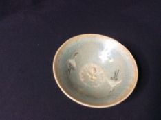 A Korean pottery bowl
Of conical form, decorated to the interior with cranes and stylised clouds.