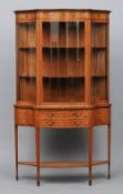 A late Victorian/Edwardian inlaid satinwood glazed display cabinet
Of serpentine bowed form with