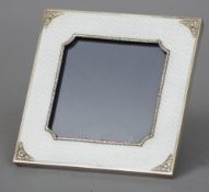 An enamel decorated silver photograph frame
The white guilloche enamel mounted with silver floral
