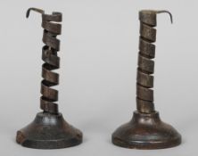 A pair of wrought iron spiral candle holders
On turned wood base.  Each 19 cm high.  (2) CONDITION