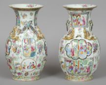 A pair of 19th century Cantonese famille rose vases
Each flared neck rim above twin butterfly