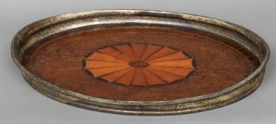 A 19th century amboyna tray
With kingwood crossbanding, central satinwood fan inlay and silver