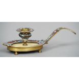 A Continental champleve decorated chamberstick
With flattened handle and flowerhead drip-pan,