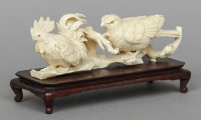 A 19th century Japanese carved ivory animalier group
Formed as cockerel and a bird of prey with