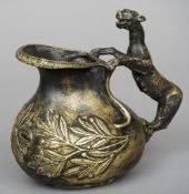 A bronze jug
The handle modelled as a leopard, the body with mistletoe sprays.  18.5 cm high.