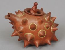 A Chinese Yixing teapot
Of unusual form with conical spiked decoration.  16.5 cm wide. CONDITION