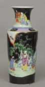 A Chinese famille noir vase
Decorated with figures in a continuous garden landscape.  46 cm high.