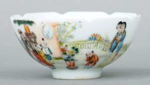 A Chinese porcelain bowl
With lappet moulded rim, the body decorated with figures and children