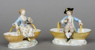 A pair of 19th century Meissen porcelain figural table salts
One formed as a boy, the other a