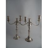 A PAIR OF SHEFFIELD PLATED TWO BRANCH THREE SCONCE TABLE CANDELABRA. Turned tapered stems and