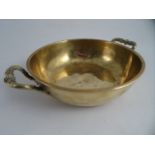 A CHRISTOFLE BRASS TWO HANDLE CIRCULAR BOWL with moulded rim and turned and fluted leaf form