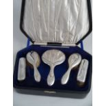 A GEORGE V SIX PIECE SILVER DRESSING SET, Birmingham 1927. Monogrammed JS in original velvet and