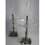 A PAIR OF CONTINENTAL SILVER TYPE METAL EPERGNES. Engraved trumpet stem vase with beaded collars