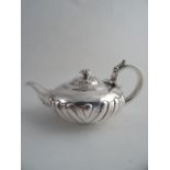 A GEORGE IV SILVER BATCHELOR'S TEAPOT, London 1821, Richard Pearce. Semi fluted circular form with