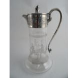 A SILVERPLATED AND ENGRAVED CLARET JUG. Lion and shield finial to the hinged lid. The glass jug