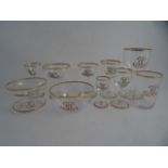 AN EDWARDIAN SUITE OF CRYSTAL GLASS, C1911. Gilded rims to bowl and foot. Each glass monogrammed AH.