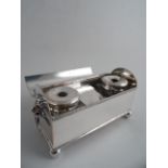 A SHEFFIELD SILVERPLATED PORTABLE INK STAND. Domed hinged cover enclosing two glass ink wells and