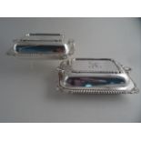 A PAIR OF SILVERPLATED RECTANGULAR ENTRÉE DISHES AND COVERS. Gadroon rim and shell decoration and