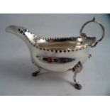 A GEORGE III SILVER SAUCE BOAT, London 1774 GS. Pinched rim with flying double scroll and leaf