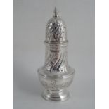 A QUEEN ELIZABETH II SILVER CASTER, London 1967 R & D. Pierced spiral twist cover and finial, flared