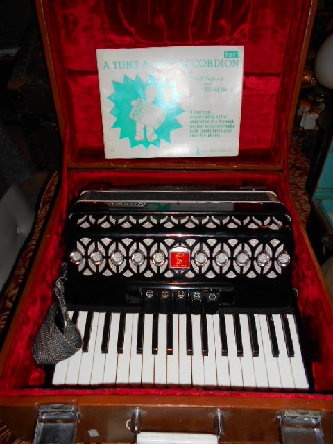 A Bai-le Studio accordion in case