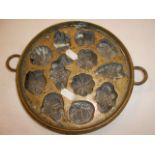 A Victorian bronze chocolate mould havin