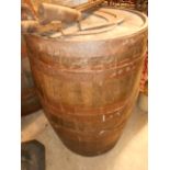 A large coopered oak metal bound barrel