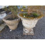 A reconstituted stone circular planter w