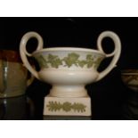 A Wedgwood white bodied and green jasper-ware urn having grape and vine applied decoration