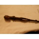 A carved African walking stick depicting