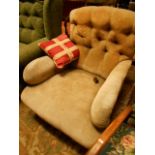 A Victorian button-back armchair having