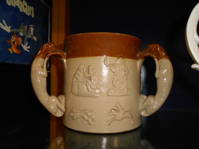 An earthen-ware tyg having toper decorat