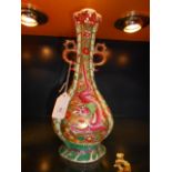 A Chinese two-handled vase having prunus, butterfly and five-toed dragon decoration, 10" high,