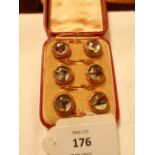 A boxed set of six yellow metal dress studs set with intaglio reverse painted Essex crystal