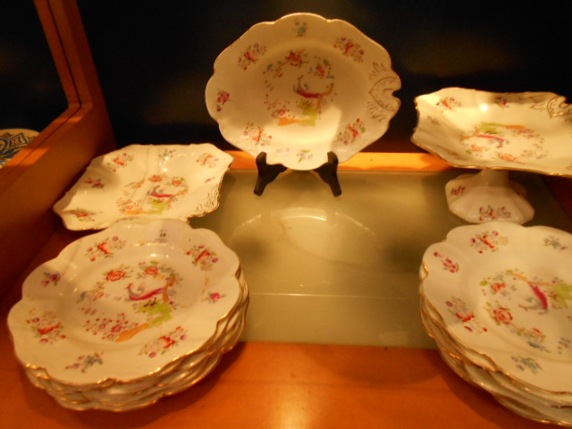 A  Staffordshire Potteries part dinner service in 'Cuckoo' pattern comprising plates, tazza,