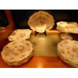 A  Staffordshire Potteries part dinner service in 'Cuckoo' pattern comprising plates, tazza,