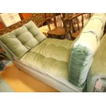 An Edwardian drop-end settee having green button upholstery