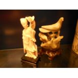 A carved Oriental soapstone figure of birds on carved wooden base and a carved ivory female figure