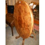 A 19th C burr walnut, oval snap top centre table,