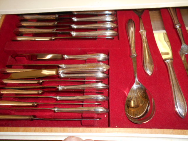 A white-painted four drawer canteen of silver plated cutlery