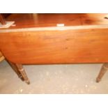 A Victorian walnut Pembroke table fitted with single drawer and raised on ring turned legs