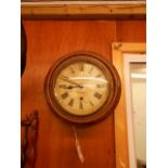A late 19th C / early 20th C circular mahogany wall clock the enamel dial with Roman numerals and