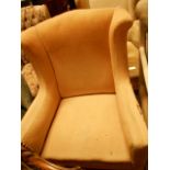 An early 20th C wing-back armchair,