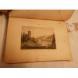 A half leather bound octavo (approx) hardback volume of engravings, both landscape and portraits,