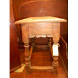 A late 18th early 19th C oak coffin stool the mould top over a shaped friezed,